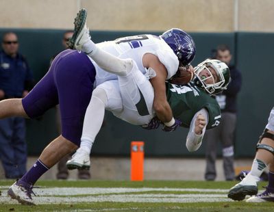 In this Oct. 15, 2016, file photo, Northwestern's Joe Gaziano, left, sacks Michigan State quarterback Brian Lewerke for a safety during the second quarter of an NCAA college football game, in East Lansing, Mich. The fall of Michigan State could end up being the most dramatic in Big Ten football since the Gerald Ford-led Michigan Wolverines went from first to worst 82 years ago. (Al Goldis / Associated Press)