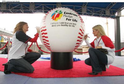 
In this photo, baseball wives Lisa Johnson, left, and Shonda Schilling sign an oversized baseball  during a Centrum publicity event. Four years ago, a dermatologist removed a suspicious mole from Schilling's back that turned out to be malignant melanoma. Six surgeries removed additional melanomas from her back, legs, chest and arms. She was 33. Her Shade Foundation of America  is an  educational resource about sun safety procedures and detecting and preventing skin cancer. 
 (Feature Photo Service / The Spokesman-Review)