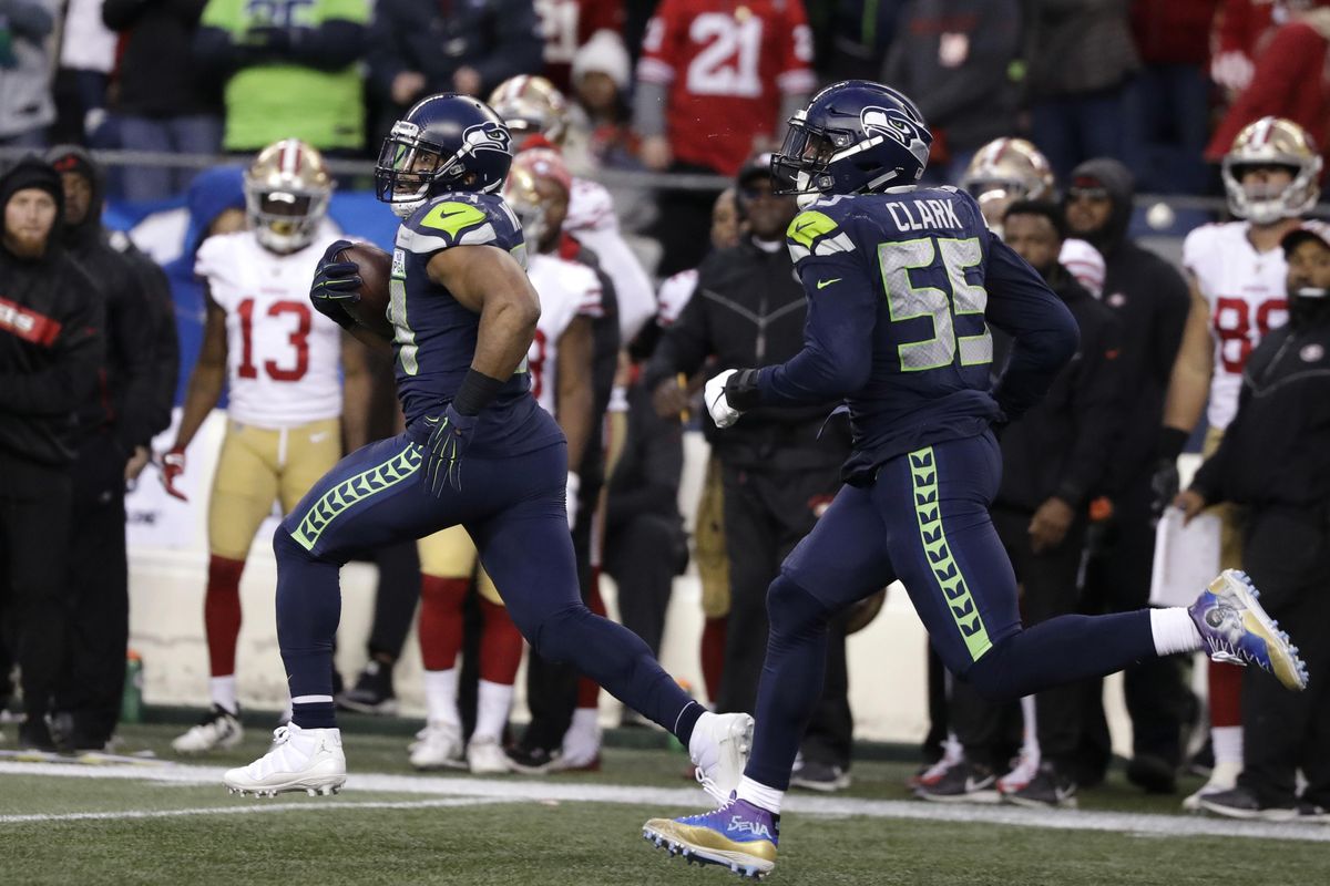 Seattle Seahawks middle linebacker Bobby Wagner, left, runs with defensive end Frank Clark (55) after intercepting a pass and running for a 98-yard touchdown against the San Francisco 49ers during the second half of an NFL football game, Sunday, Dec. 2, 2018, in Seattle. (Elaine Thompson / Associated Press)