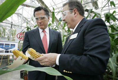 
Republican presidential candidate former Massachusetts Gov. Mitt Romney, left,  tours  the Pioneer Hybrids research facility  Wednesday in Johnston, Iowa. 
 (Associated Press / The Spokesman-Review)