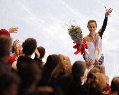 
Sasha Cohen waves to the crowd after her victory in Skate America in 2003. Cohen has switched back to her old coach after a trying 2004.
 (Associated Press / The Spokesman-Review)