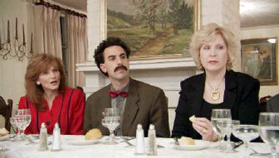 
Comedian Sacha Baron Cohen, center, with etiquette consultant Cindy Streit, left, and Sarah Moseley, both of Birmingham, Ala. The two unknowingly became the target of British comedian Baron Cohen's outrageous humor in his movie satire. 
 (Associated Press / The Spokesman-Review)