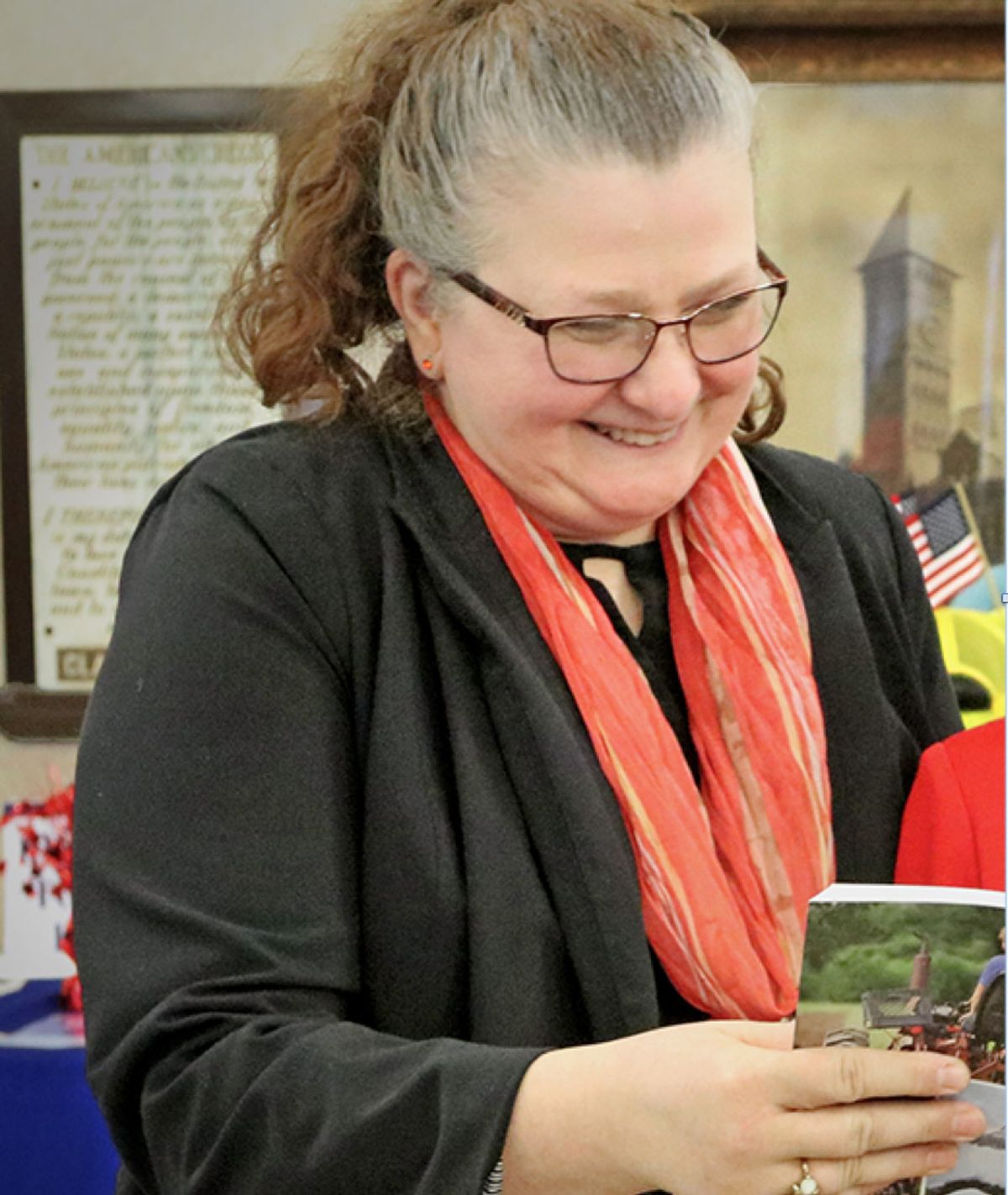 Spokane Public Schools’s Secondary Social Studies Coordinator Susie Gerard reviews a copy of “The State We’re In,” a civics education textbook for middle and high school students produced by the League of Women Voters of Washington.  (Courtesy)