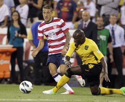 Jamaica’s Nyron Nosworthy, right, kicks the ball away from United States’ Fabian Johnson. (Associated Press)