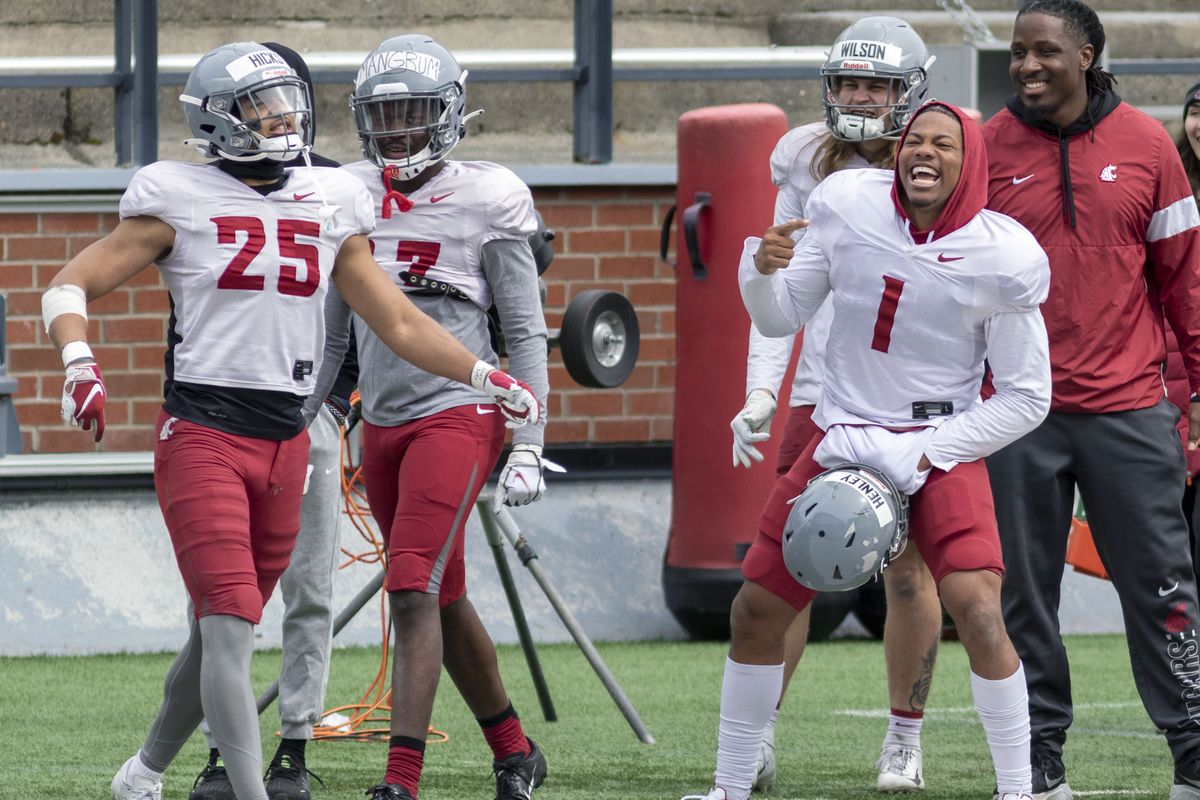 Washington State linebacker Daiyan Henley (1) celebrates with teammates during a scrimmage on Saturday at Gesa Field in Pullman. (Geoff Crimmins/For The Spokesman-Review)