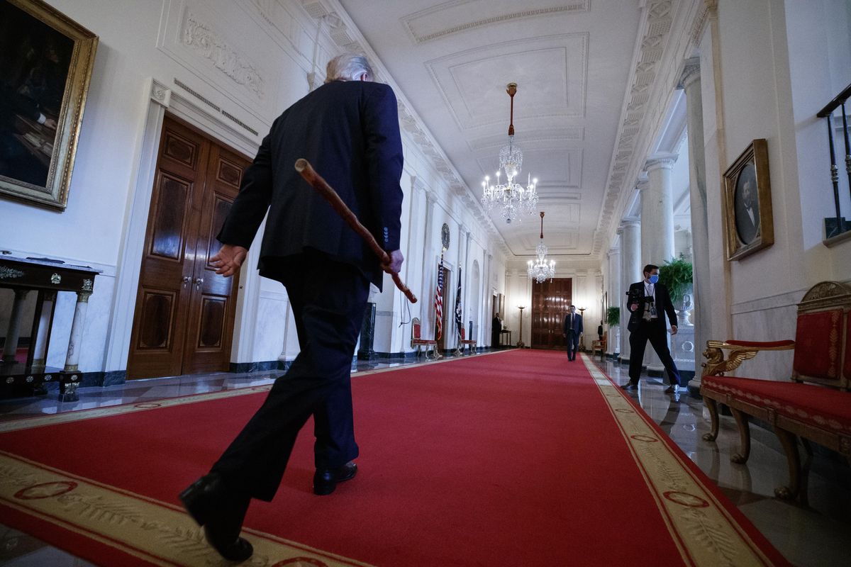 President Donald Trump departs carrying a walking stick given to him by Sen. Lamar Alexander, R-Tenn., after a signing ceremony for H.R. 1957 – "The Great American Outdoors Act," in the East Room of the White House, Tuesday, Aug. 4, 2020, in Washington. (Alex Brandon)