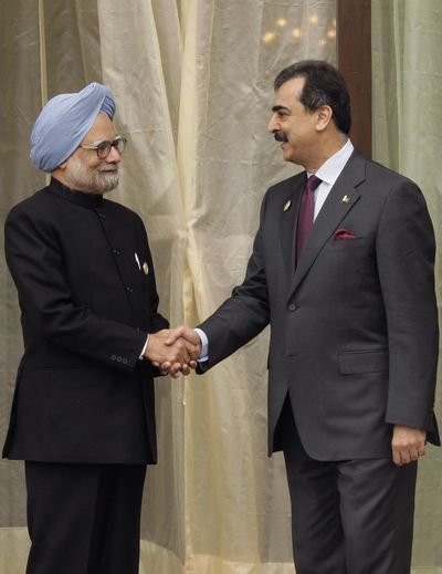 Indian Prime Minister Manmohan Singh, left, shakes hands with Pakistan’s Prime Minister Yusuf Raza Gilani  in Thimphu, Bhutan, on Thursday.  (Associated Press)
