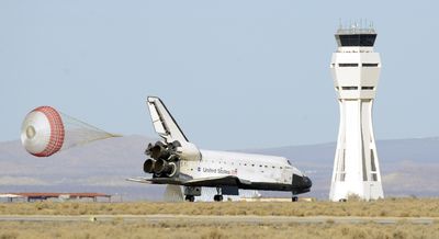 A parachute deploys as the space shuttle Endeavour touches down Sunday at Edwards Air Force Base in California.  (Associated Press / The Spokesman-Review)