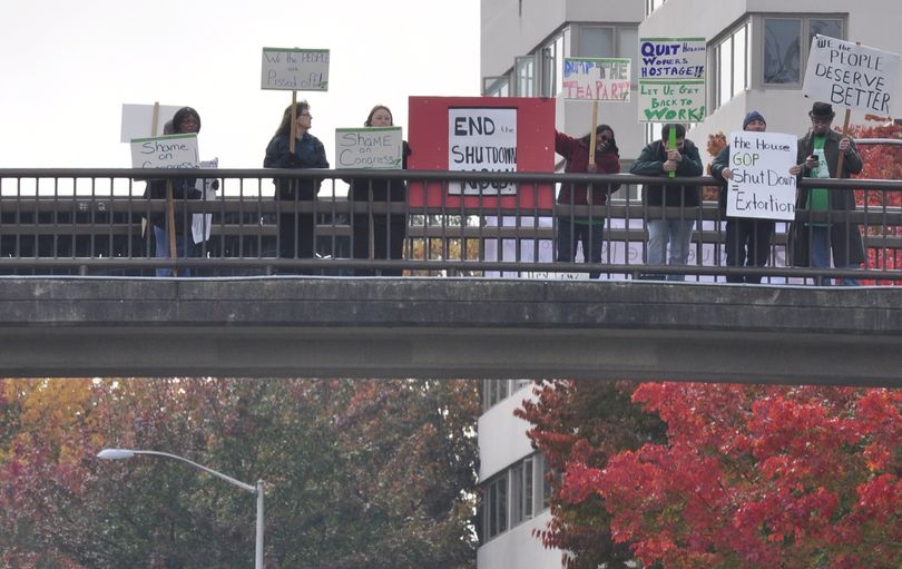 OLYMPIA -- Members of public employees' unions gather on the walkway over Capitol Boulevard to protest the federal government's partial shutdown and demand Congress end it. (Jim Camden)