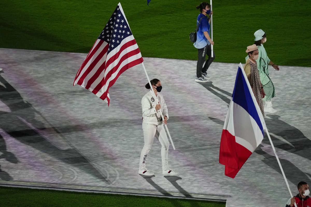 Kara Winger, of the United States of America, and Steven Da Costa, of France, carry their country