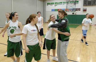 
Kelsi Jacobson is greeted by Torie Nee and some of her East Valley teammates at practice Monday. She is one of the GSL's leading scorers but hurt her knee in the state qualifing game. The Knights won the game. 
 (J. BART RAYNIAK / The Spokesman-Review)