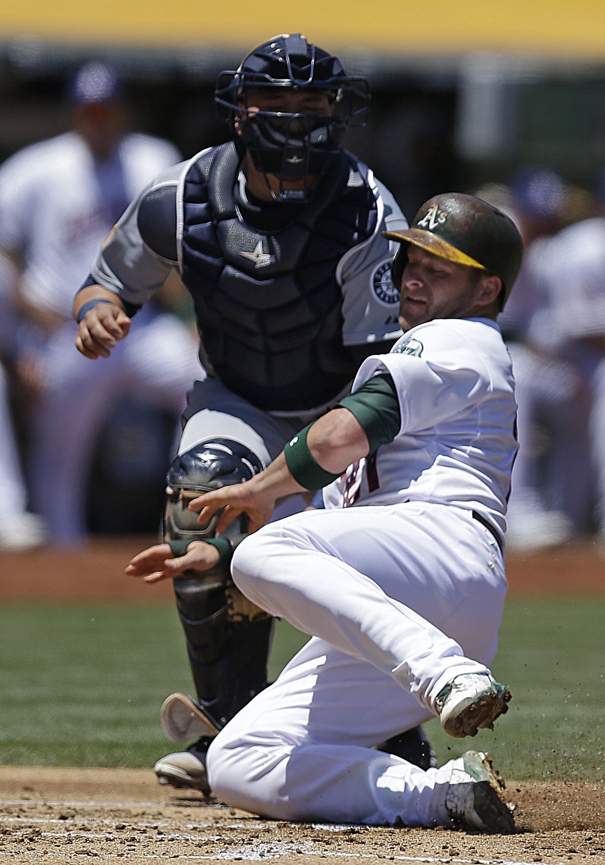 Mariners catcher Jesus Sucre tags out Stephen Vogt on failed double-steal attempt. (Associated Press)