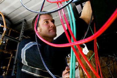 
Washington State University engineering student Josh Dewinter works last week on a power monitoring system for a solar-powered house built in Pullman to compete in the global Solar Decathlon. 
 (Christopher Onstott/Spokesman-Review / The Spokesman-Review)