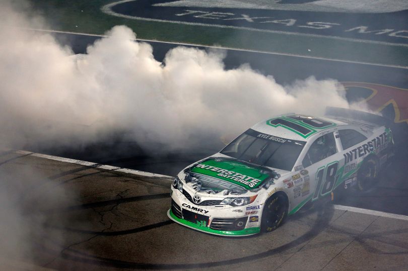 Kyle Busch, driver of the #18 Interstate Batteries Toyota, celebrates with a burnout after winning the NASCAR Sprint Cup Series race at Texas Motor Speedway on April 13, 2013 in Fort Worth, Texas. (Photo Credit: Todd Warshaw/NASCAR via Getty Images) (Todd Warshaw / Nascar)