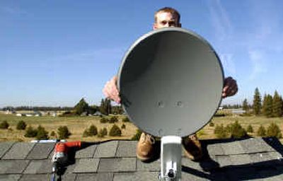 
Keith Gipe, of Air-Pipe Inc., installs a wireless Internet dish. The dish allows Internet downloads and uploads as fast as some wired services at about the same cost.  Keith Gipe, of Air-Pipe Inc., installs a wireless Internet dish. The dish allows Internet downloads and uploads as fast as some wired services at about the same cost.  
 (Jed Conklin/Jed Conklin/ / The Spokesman-Review)