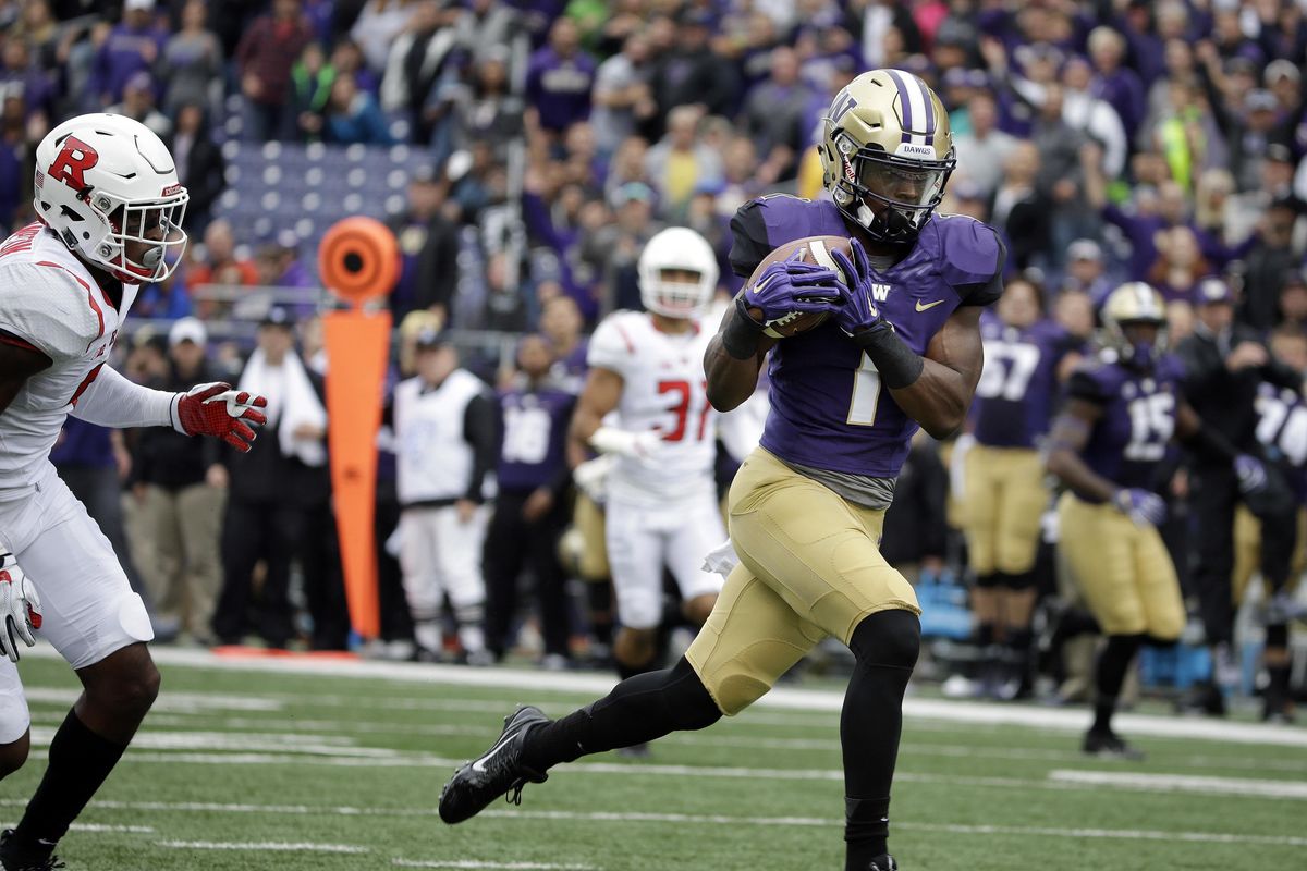 Washington’s John Ross scores on a 50-yard pass against Rutgers in the first half of an NCAA college football game, Saturday, Sept. 3, 2016, in Seattle. (Elaine Thompson / Associated Press)