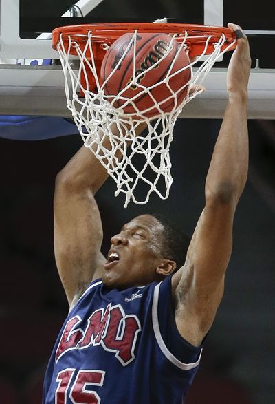 Loyola Marymount's Alex Osborne dunks against Portland. (Associated Press)