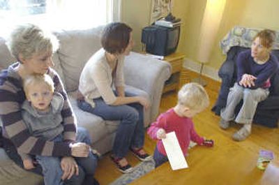 
Maria Larson, left, Jenny Eck and Charlotte Lauerman, who are part of a group of friends that gathers often so they can spend time together while their children play, chat in Helena. Also pictured are kids Daniel Larson, left, and Owen Eck.
 (The Spokesman-Review)