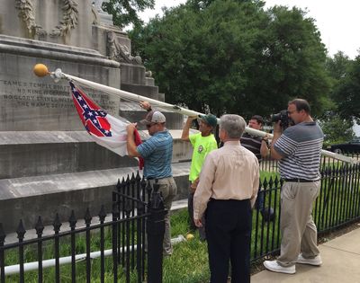 State workers take down a Confederate national flag on the grounds of the state Capitol, Wednesday, in Montgomery, Ala. (Associated Press)