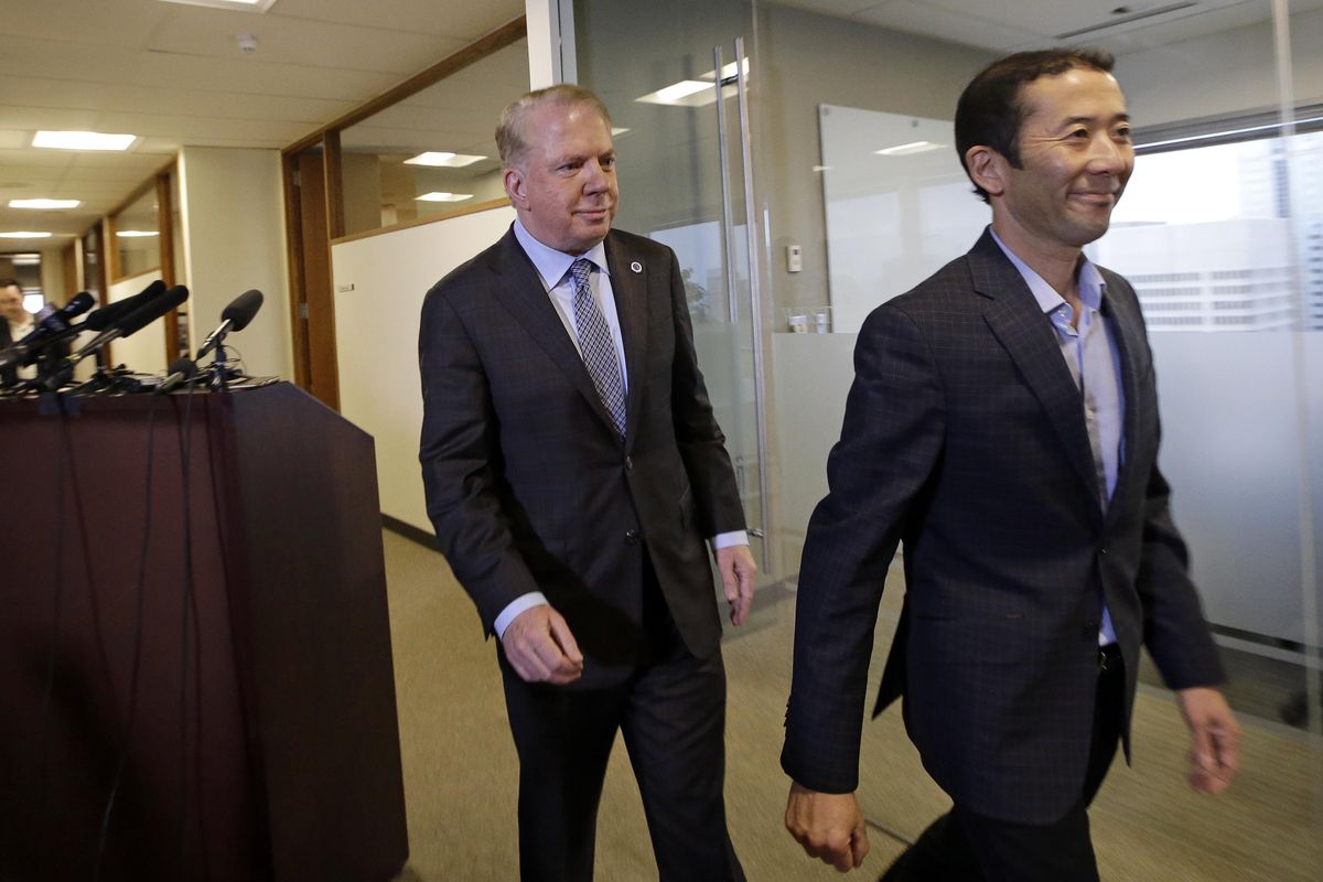 Seattle Mayor Ed Murray, left, walks away with his husband, Michael Shiosaki, after reading a statement to the media, Friday, April 7, 2017, in Seattle. Councilwoman Sally Bagshaw has come forward as the first public official to back Murray after a lawsuit last week accused him of sexually molesting a teenage high school dropout in the 1980s. (Elaine Thompson / AP)