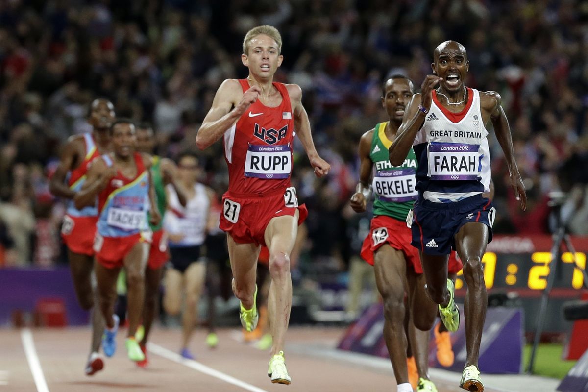 Britain’s Mo Farah and training partner Galen Rupp of the U.S. kick toward the finish of the men’s 10,000 meters, where they won gold and silver, respectively. (Associated Press)
