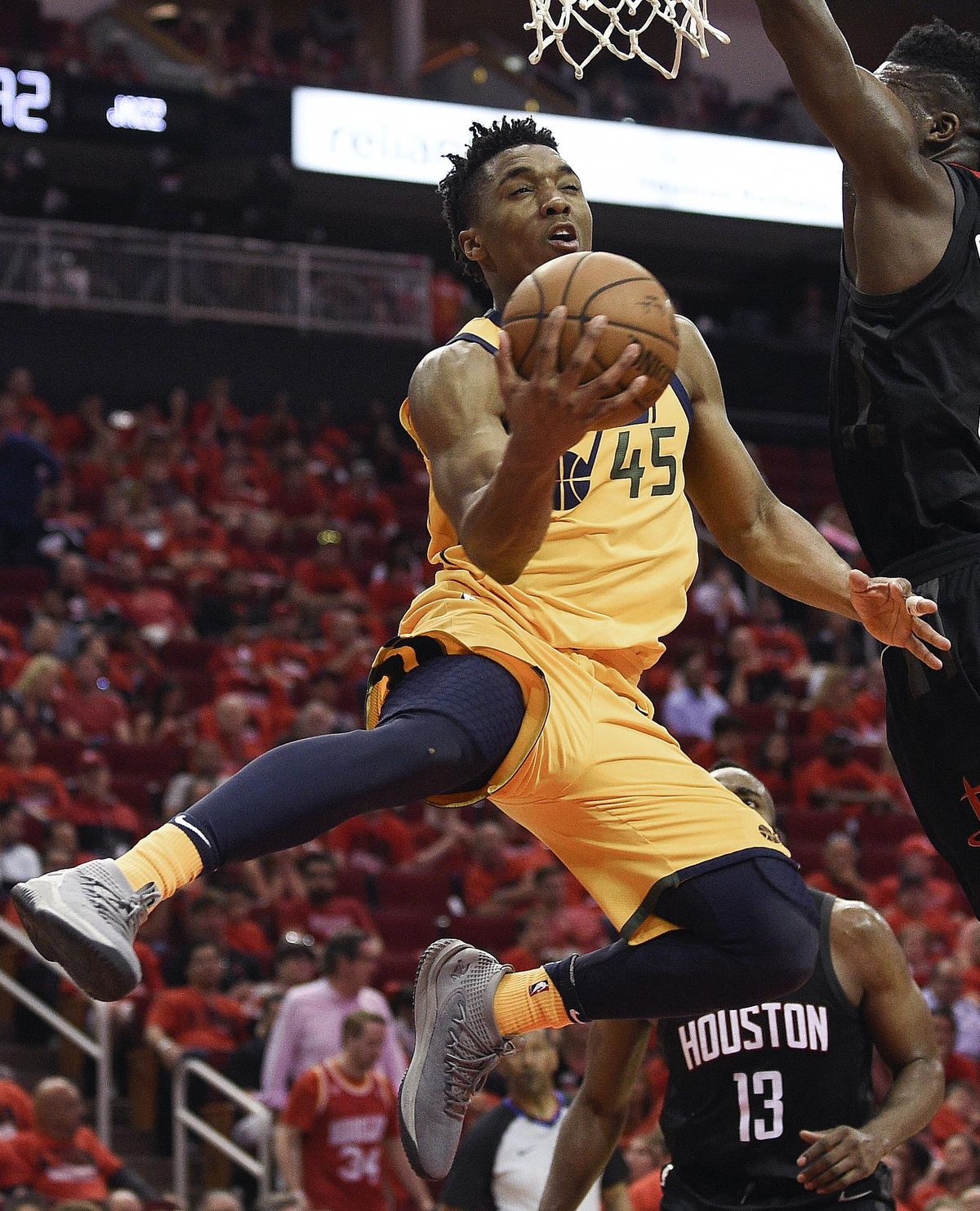 Utah Jazz guard Donovan Mitchell (45) drives to the basket as Houston Rockets center Clint Capela, right, defends during the second half in Game 1 of an NBA basketball second-round playoff series Sunday, April 29, 2018, in Houston. (Eric Christian Smith / Associated Press)