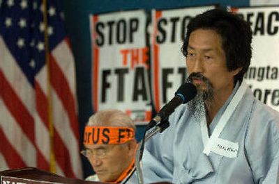 
Kang Kikab, a member of the National Assembly of South Korea, right, addresses the media during a news conference at the National Press Club in Washington on Monday, while Co-Chairman of the Korean Alliance Against KORUS FTA (KoA) Oh Jongryul looks on. 
 (Associated Press / The Spokesman-Review)