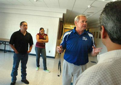 
Larry Schwenke, athletic director at Coeur d'Alene High School, talks with a group of business people about his school, and its lack of a teen gang problem, on Friday in Coeur d'Alene. The group was from a company being recruited by Jobs Plus, the economic development agency. 
 (Jesse Tinsley / The Spokesman-Review)