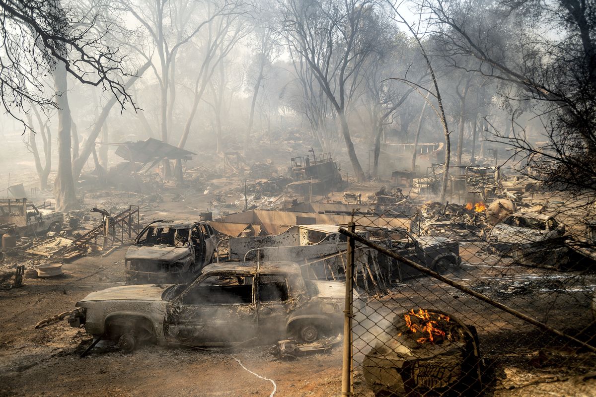 Scorched cars line a property as the Cache Fire burns on Wednesday, Aug. 18, 2021, in Clearlake, Calif. The fire destroyed dozens of homes.  (Noah Berger)