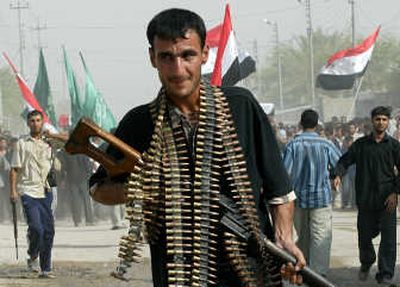
An Iraqi carries a Russian-designed machine gun at a funeral in Karbala, an Iraq city dominated by Shiite Muslim militias. Associated Press
 (Associated Press / The Spokesman-Review)