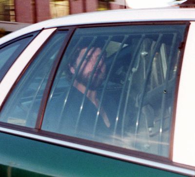 Robert Berry is seen in the back of a police cruiser on his way to the federal courthouse for a hearing in this October 1996 photo.   (Dan McComb/The Spokesman-Review)