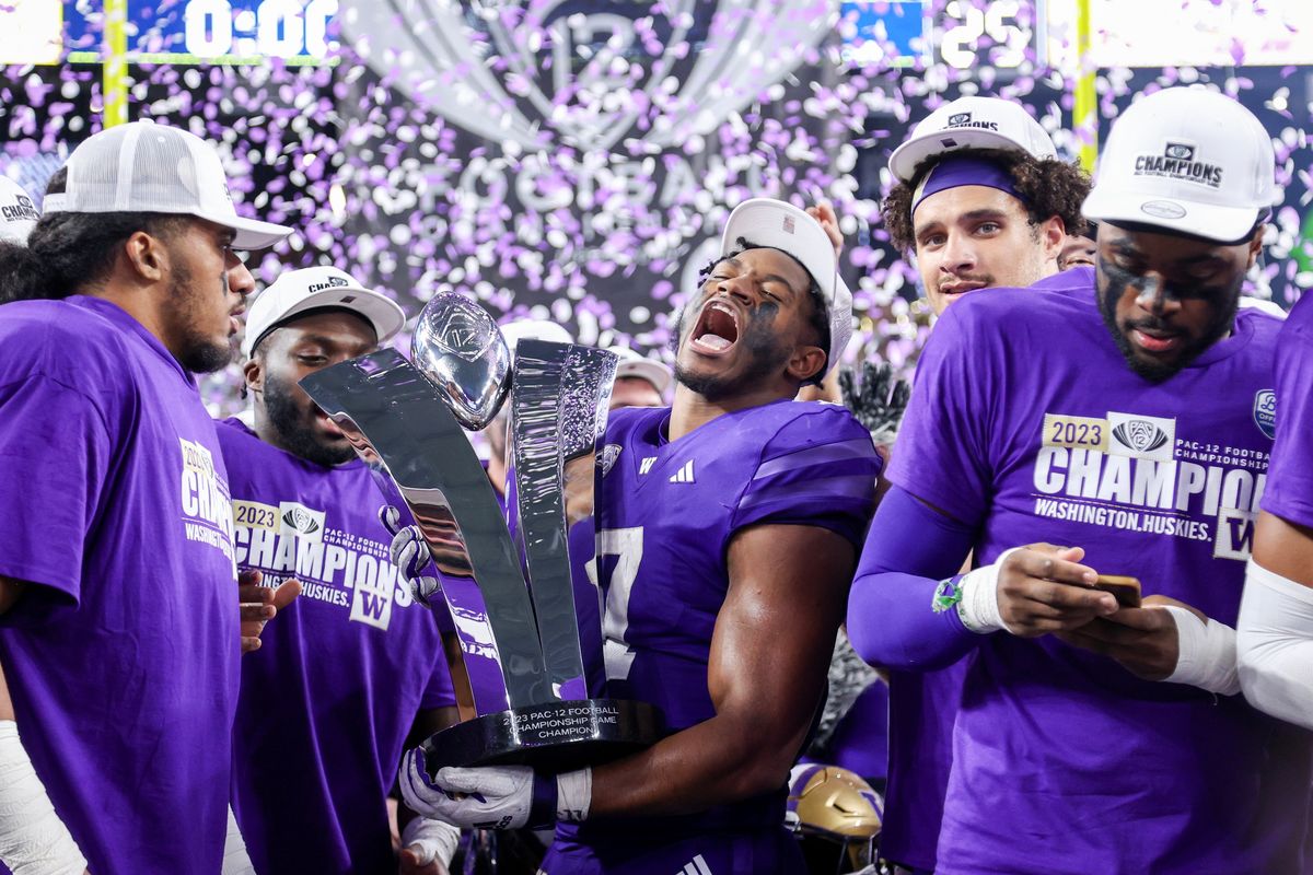 Washington’s Dillon Johnson yells Friday while holding the Pac-12 Championship trophy after his team’s 34-31 win against Oregon at Allegiant Stadium in Las Vegas.  (Getty Images)