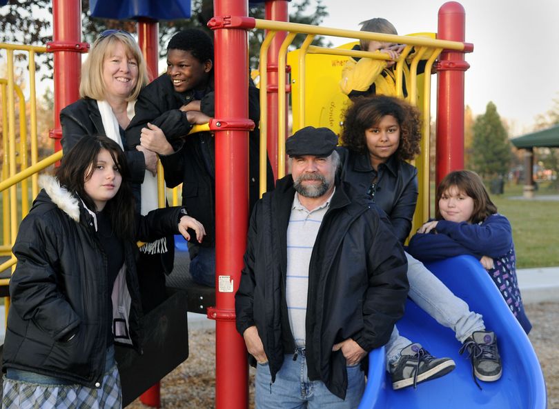 Debbie and Barry Officer and their children, from left, Suzanna, 13,  Peter, 12,  Polly, 12, Gus (top right back) and Samantha, 12, gather for a photo  at Franklin Park Nov. 3 in Spokane. (Dan Pelle / The Spokesman-Review)