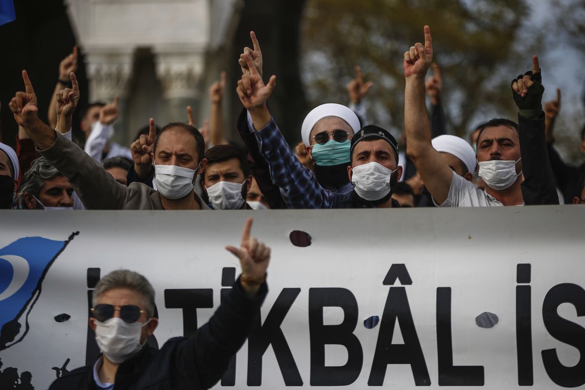Demonstrators chant slogans during an anti-France protest in Istanbul, Sunday, Oct. 25, 2020. Turkish President Recep Tayyip Erdogan on Sunday challenged the United States to impose sanctions against his country while also launching a second attack on French President Emmanuel Macron. Speaking a day after he suggested Macron needed mental health treatment because of his attitude to Islam and Muslims, which prompted France to recall its ambassador to Ankara, Erdogan took aim at foreign critics.  (Emrah Gurel)