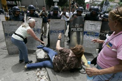 Women protest in front of riot police officers Wednesday during a demonstration against President Chavez in Caracas, Venezuela. (Associated Press / The Spokesman-Review)