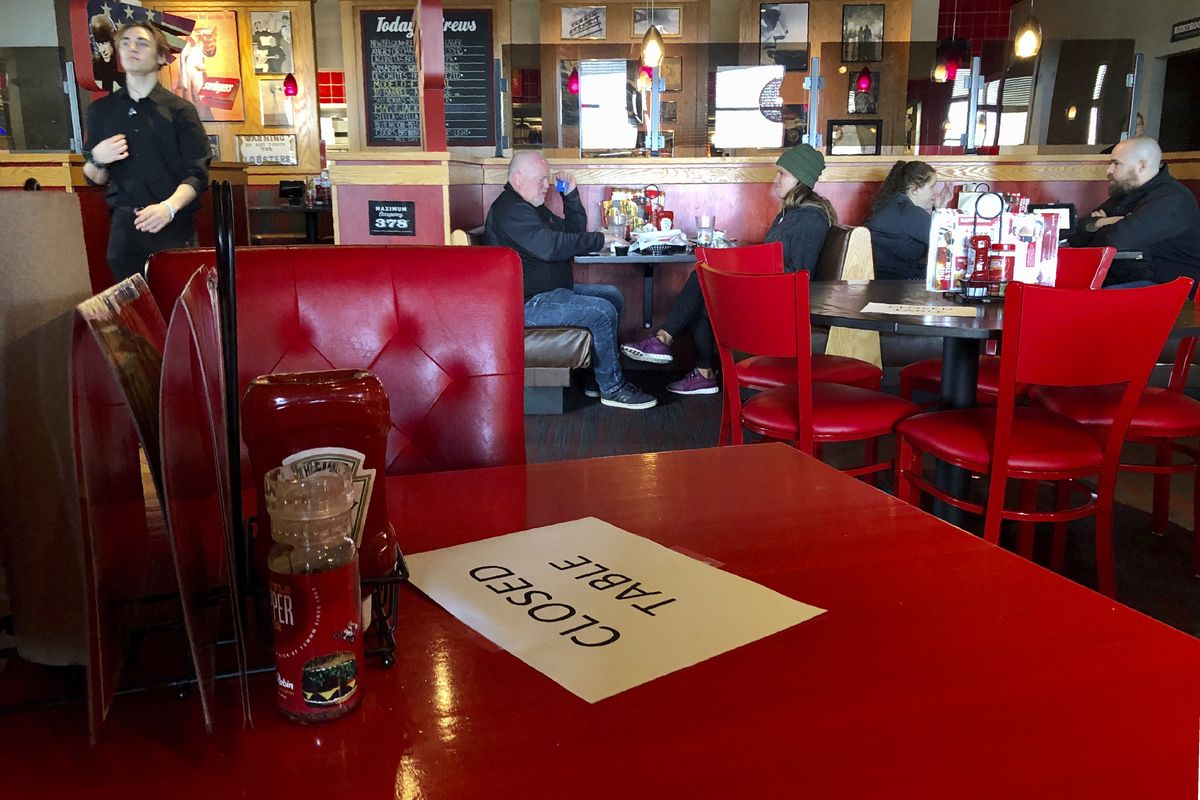 A Red Robin restaurant in Tigard, Ore., closed some tables in order to maintain social distancing on March 15.  (Associated Press)