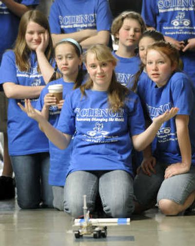 
Lauren Carroll, center, an eighth-grader at St. Aloysius Catholic School, and her team watch their hydrogen car fizzle out after traveling only a few feet during a first-round preliminary heat at the Northwest Regional Science Bowl and Hydrogen Fuel Cell Car Race held Friday at Gonzaga University. 
 (Dan Pelle / The Spokesman-Review)