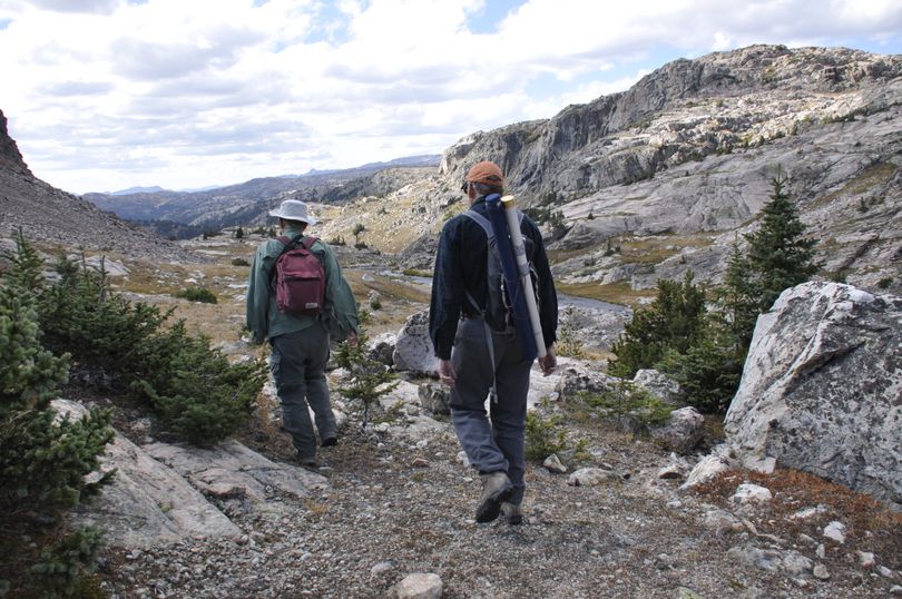 Al Goldner and Scott Wolff hike along a stream connecting two fishing lakes during a day-hike from a base camp to sample trout-holding waters in the Absaroka-Beartooth Wilderness near Cooke City, Mont. (Rich Landers)