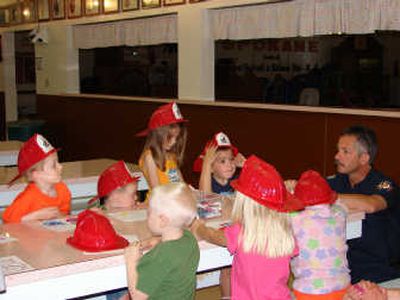 
Bill Clifford of Spokane Valley Fire Department talks with children at the 2007 KinderCamp as part of safety town week. Courtesy of Carolbelle Branch
 (Courtesy of Carolbelle Branch / The Spokesman-Review)