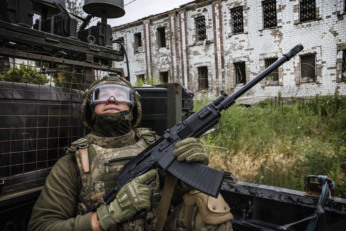 FILE — A Ukrainian soldier with the 53rd Mechanized Brigade in the back of a fast-moving truck stays on the lookout for Russian drones in the city of Kostyantynivka, Ukraine, June 19, 2025. Moscow wants Ukraine to unilaterally withdraw from the entire eastern region known as the Donbas. For a variety of military, humanitarian and political reasons, Ukrainians find it difficult to imagine.   (David Guttenfelder/The New York Times)