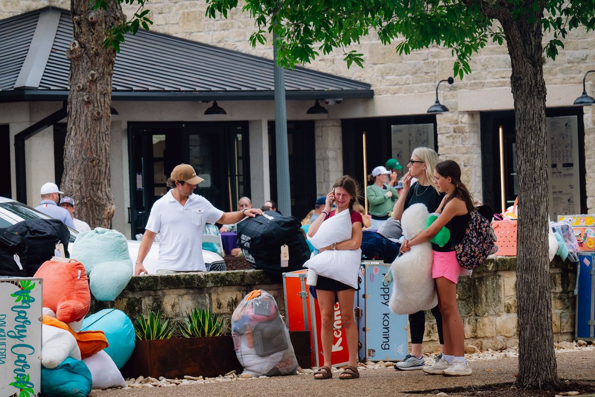 A young girl from Camp Waldemar cries outside a reunification center on Saturday in Kerrville, Texas. (Desiree Rios/For The Washington Post)