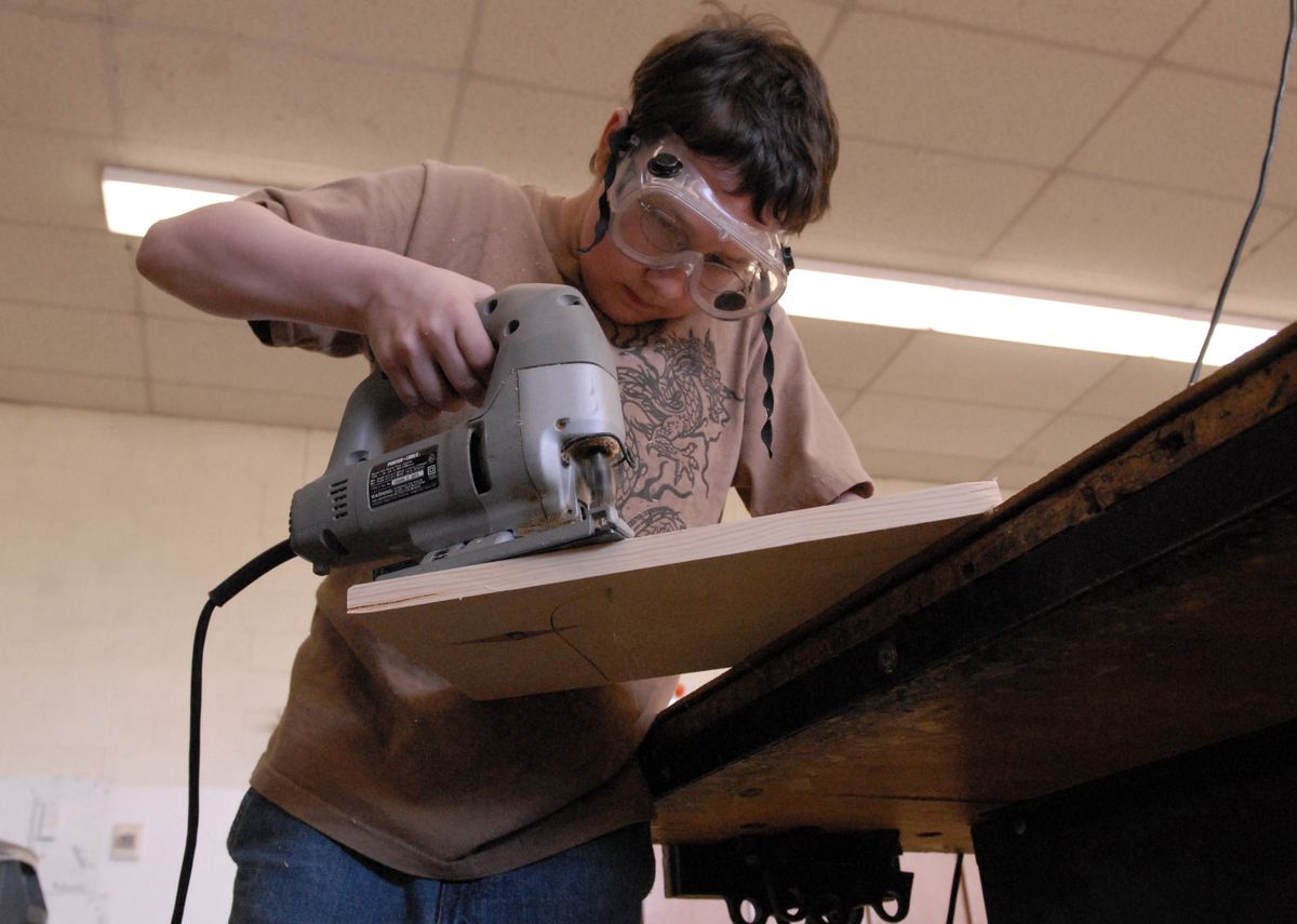 Jon Tipton uses a sabre saw to cut an Easter basket in a woodworking class at EVMS. A 21st Century Grant is paying for the two-hour programs that help boost math performance. (J. Rayniak / The Spokesman-Review)