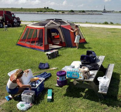 
Kathy Callahan and Norman Hansen, of Bayonet Point, Fla., set up camp at Jetty Park across from the Kennedy Space Center Tuesday in Cape Canaveral, Fla. The couple will have a prime location to watch today's expected liftoff of Discovery.
 (The Spokesman-Review)