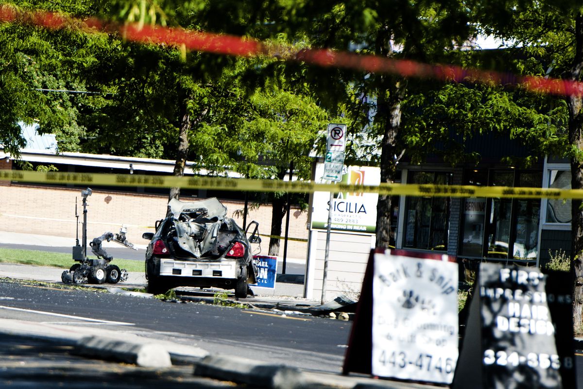 A bomb disposal robot is used to investigate a car explosion on Aug. 4 near the Garland Avenue and Howard Street intersection that seriously injured a man and his 3-year-old daughter. (File)