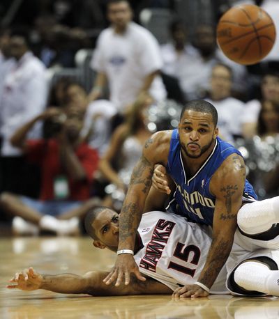 Hawks center Al Horford (15) and Magic point guard Jameer Nelson scramble for a loose ball in the second quarter. (Associated Press)