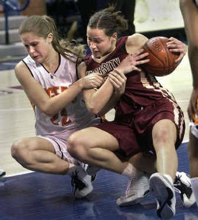 
Lewis and Clark's Hanna Rothstrom (22) tries to wrestle the ball from U-Hi's Jami Bjorkund during the 4A finals.
 (Dan Pelle / The Spokesman-Review)