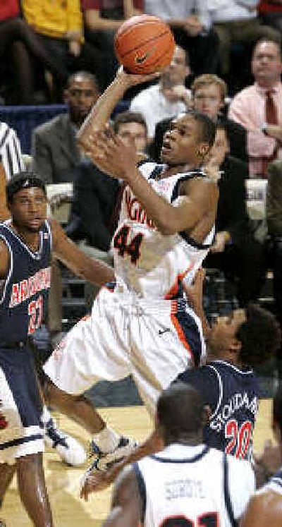 
Virginia's Sean Singletary drives to the basket in an upset over Arizona. 
 (Associated Press / The Spokesman-Review)