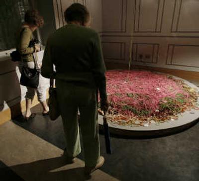 
Visitors examine part of artist Wenda Gu's 