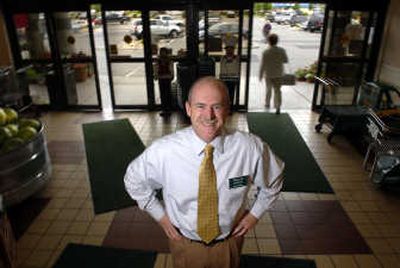 
Willie Maddox stands in the entryway of Yoke's Foods in Mead recently, where he works as a financial adviser out of an Edward Jones Investments branch office. 
 (Jed Conklin / The Spokesman-Review)