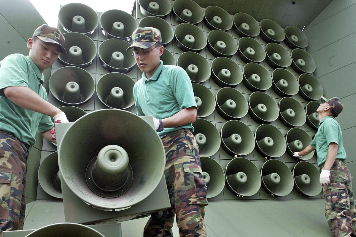In this June 16, 2004, file photo, South Korean army soldiers remove loudspeakers used for propaganda near the demilitarized zone between South and North Korea, in Paju, South Korea. South Korea says it will remove propaganda-broadcasting loudspeakers from the tense border with North Korea. The announcement came three days after the leaders of the two Koreas agreed to work together to achieve a nuclear-free Korean Peninsula and end hostile acts against each other along their border during their rare summit talks. Seouls Defense Ministry said Monday, April 30, 2018, it will pull back dozens of its frontline loudspeakers on Tuesday. (Lee Jin-man / Associated Press)